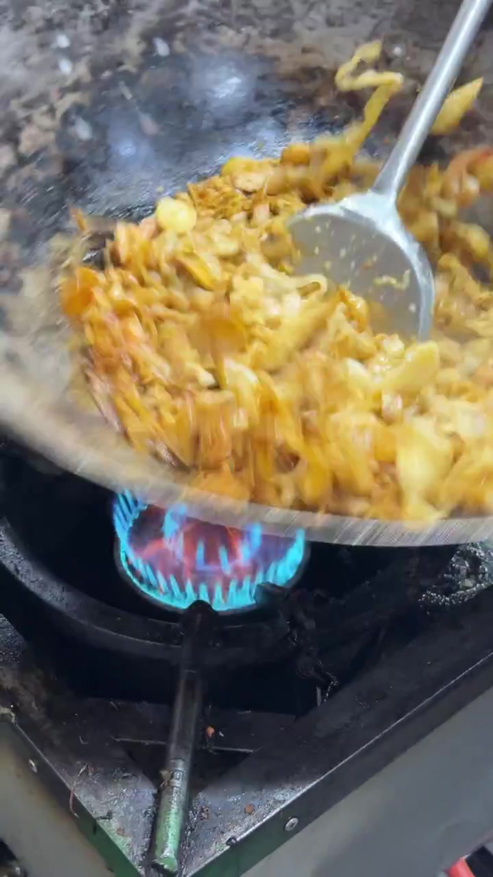 Chef Stir-Frying Pad Thai Noodles in a Wok