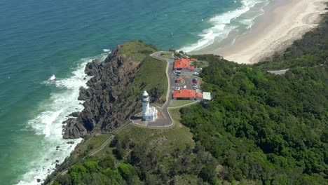 Orbiting-aerial-shot-of-famous-Cape-Byron-Lighthouse-on-Australia's-northern-coast,-New-South-Wales,-Australia