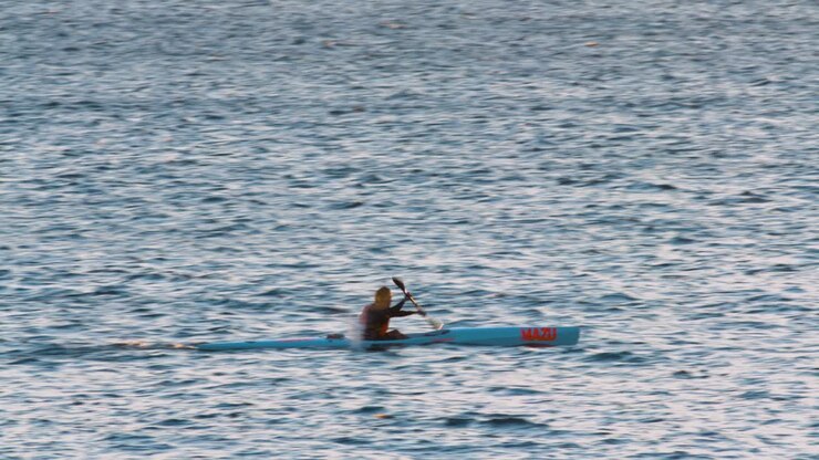 Man practicing canoeing very fast on the ocean in Atlantic sea, Portugal