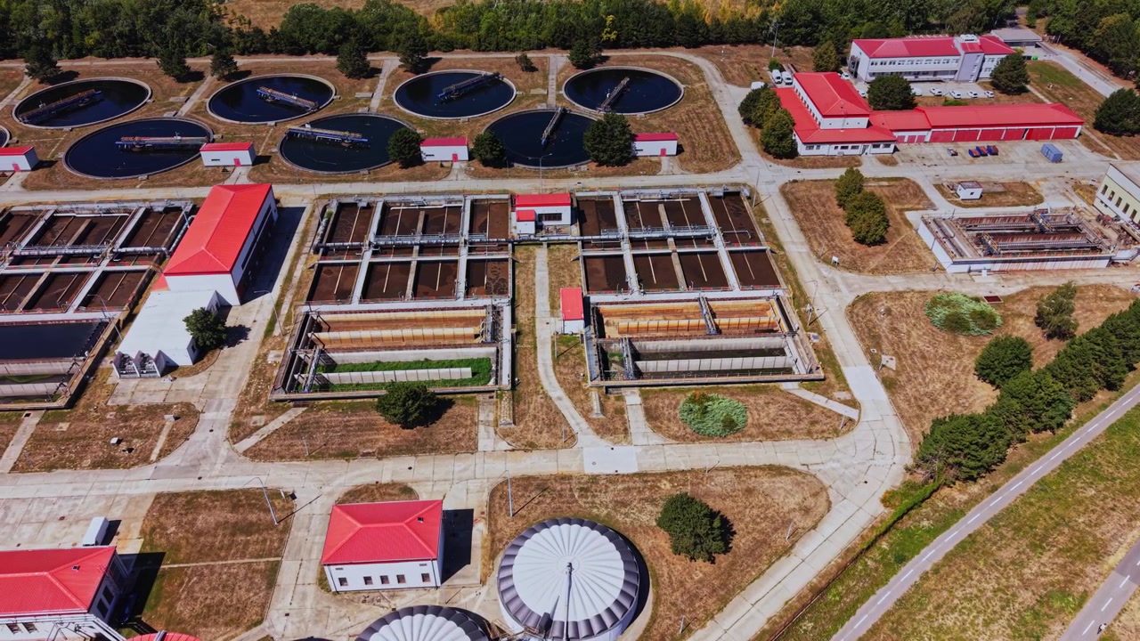 Water treatment facility with tanks and buildings during daytime