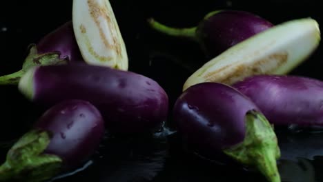 reversed shot of sliced eggplant splashes down into a pile