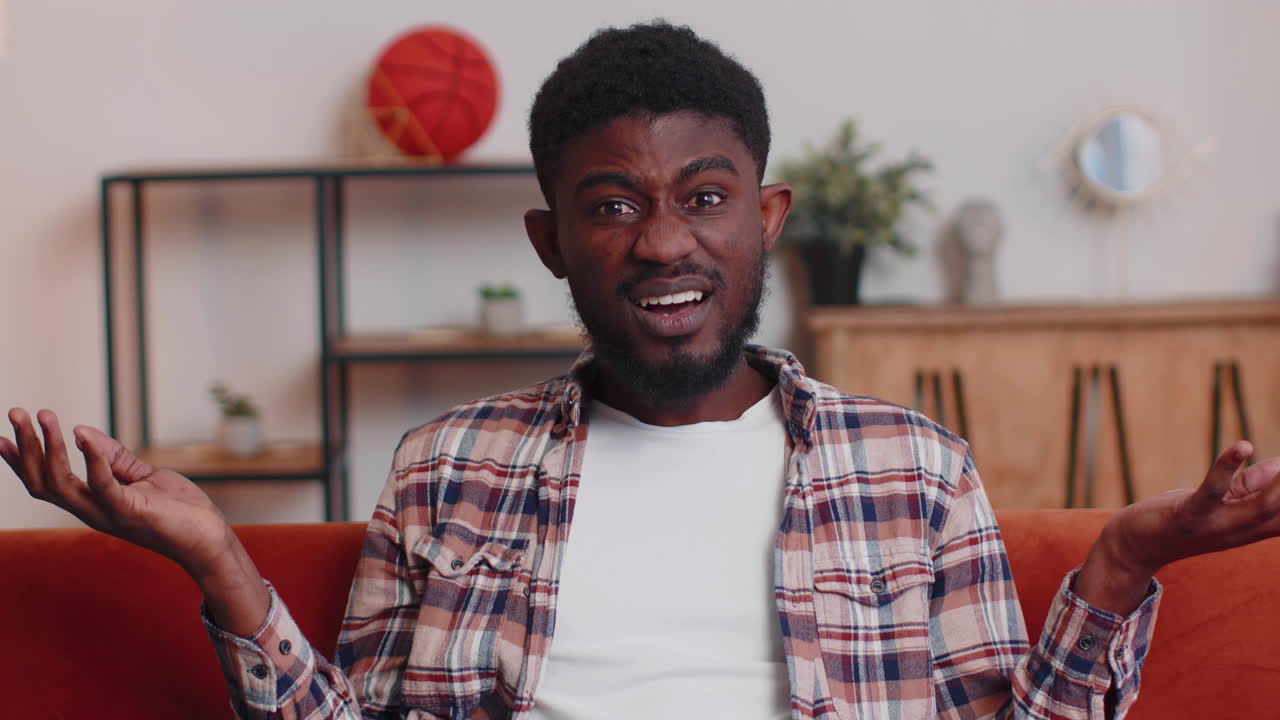 Confused man raising hands in indignant expression, asking why, what reason of failure at home