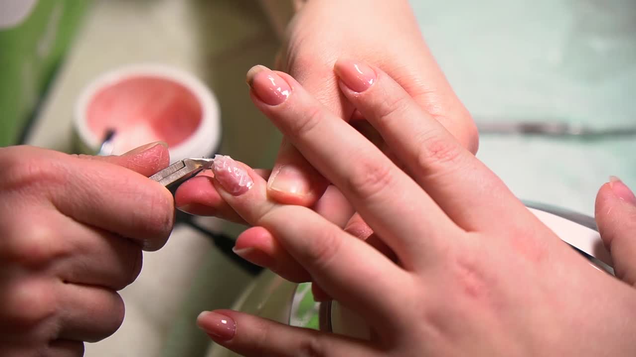 Beautiful woman cut nail by small scissor, manicure and painting, cleaning paint.