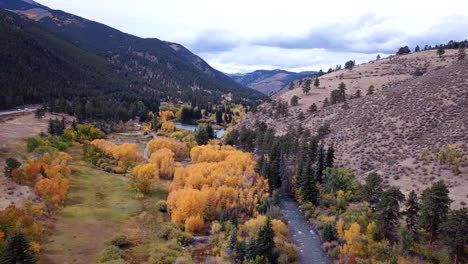 Aerial-View-of-Creek-and-Countryside-Road-in-Autumn-Season,-Campground-in-Rural-American-Countryside,-Drone-Shot