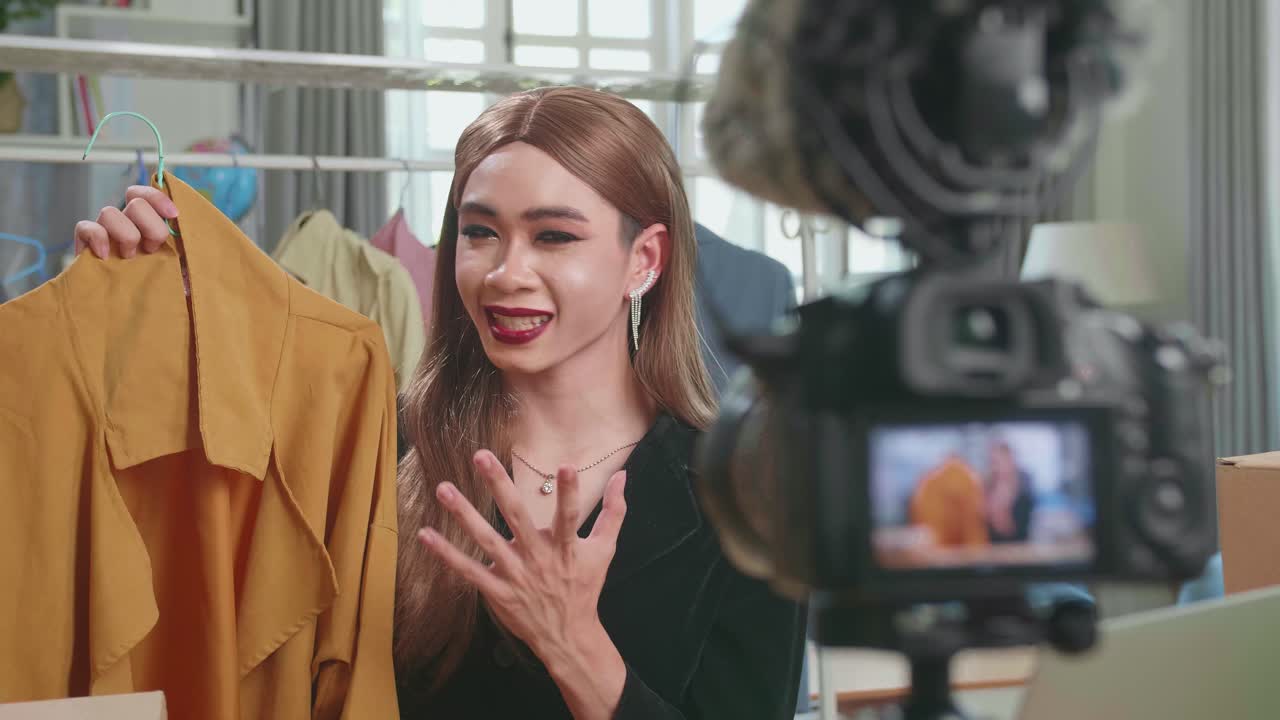 Fashion Blogger Transgender Woman Showing Casual Colorful Shirts On Camera. Stylist Influencer Transgender Woman Showing Trendy Clothes Filming Vlog Episode