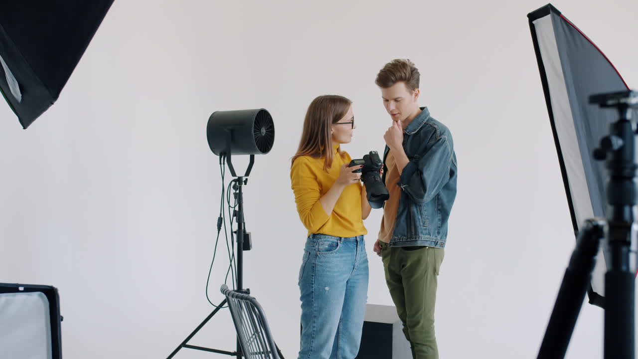 Photographer assisting model in studio