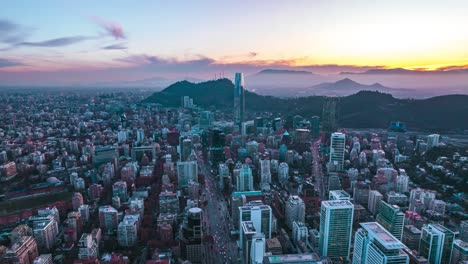 Aerial-Drone-Orbits-El-Golf-Neighborhood-Santiago,-Chile-Metropolitan-Urban-City-Area-of-Expensive-Residences,-Sunset-Around-Andean-Cordillera-Mountains