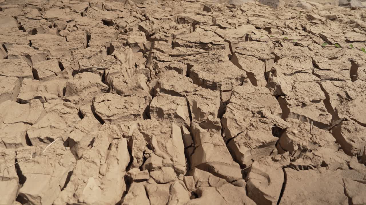 Close view of parched soil plates shaped by dry season heat and low water, agriculture exposed to climate stress