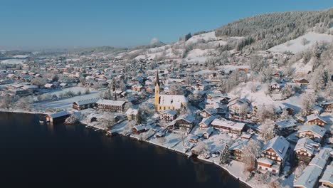 village with a church at lake schliersee in bavaria