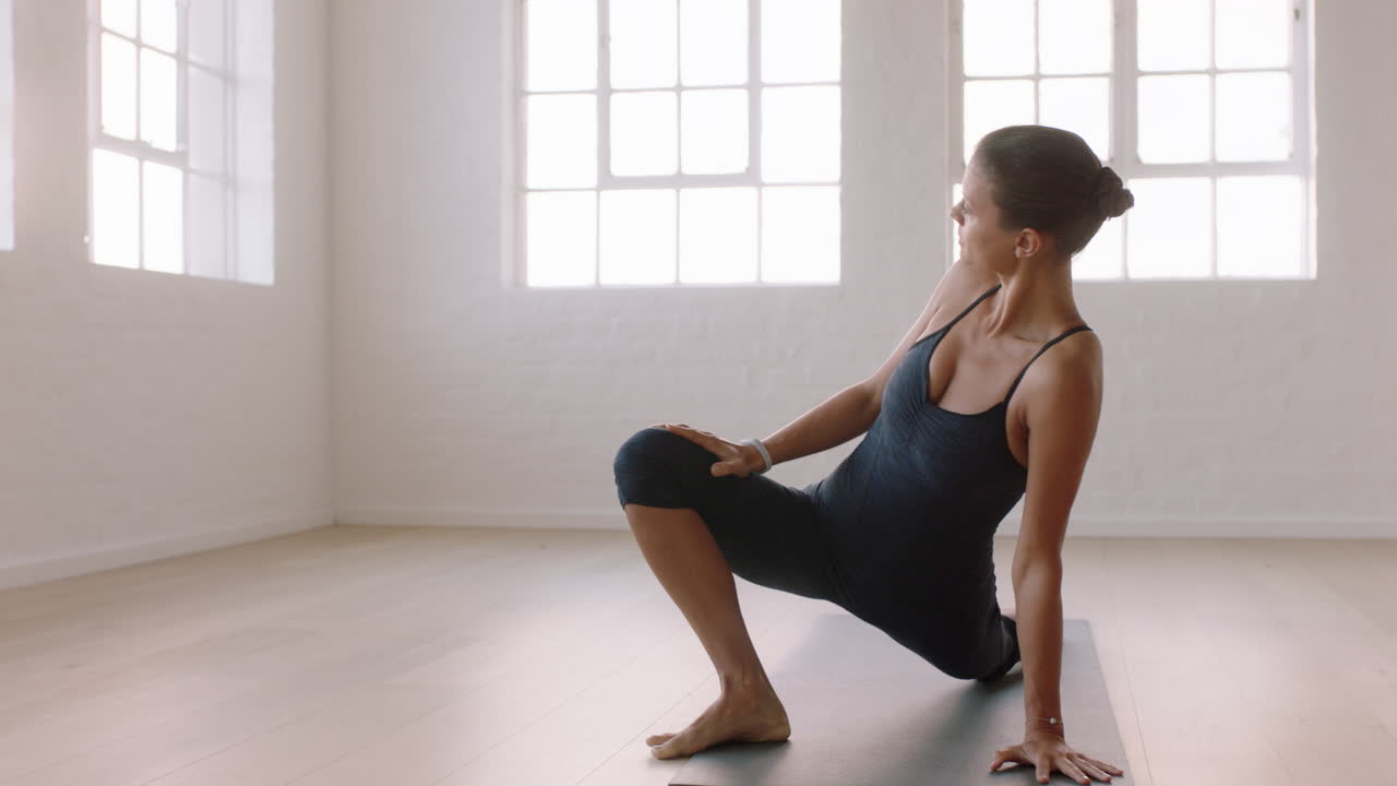 hermosa mujer de yoga practicando poses disfrutando del estilo de vida fitness haciendo ejercicio en el estudio estirando el entrenamiento corporal flexible meditación temprano en la mañana en la colchoneta de ejercicios