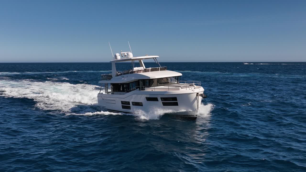 Slow motion drone shot of luxury boat driving at sea