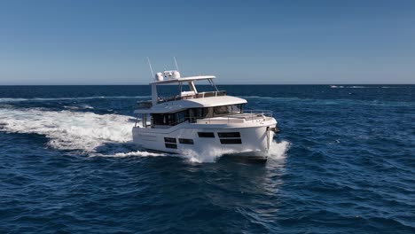 slow motion drone shot of luxury boat driving at sea