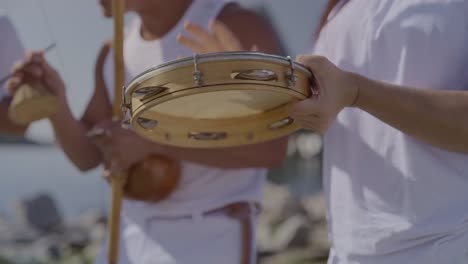 people playing traditional capoeira instruments
