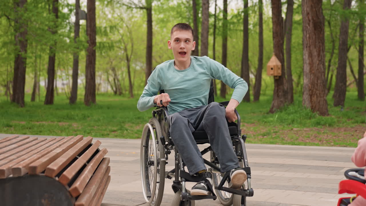 Energetic Man Exploring, Happy Man Using Wheelchair Outdoors, Vibrant Person In Wheelchair Traversing Nature Path Happily, Enthusiastic Man With Mobility Aid Exploring Scenic Park Environment Happily