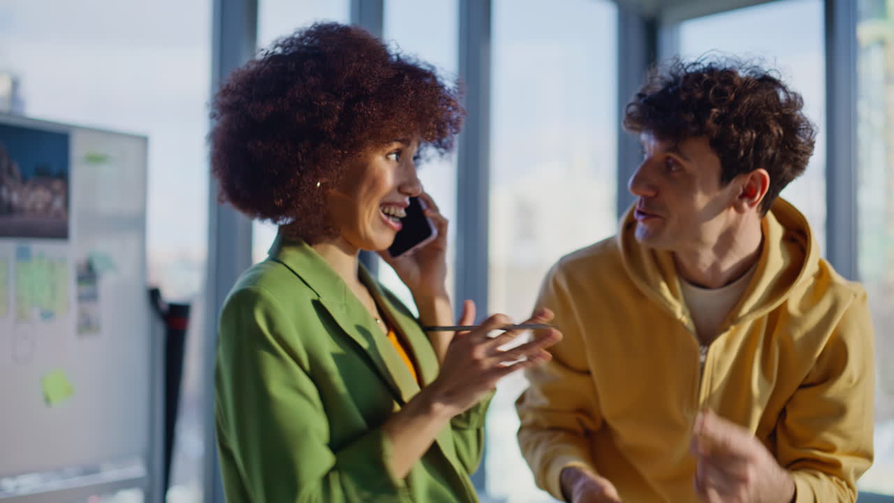 Construction managers discussing models urban area by phone in office closeup