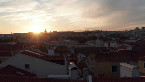 Slow-aerial-slider-view-of-red-rooftops-with-colorful-old-houses-and-churches-in-urban-city-center-of-Lisbon,-Portugal