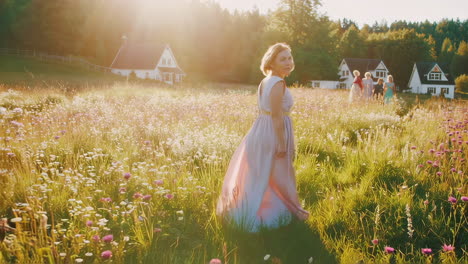 women walking in a field of flowers at sunset