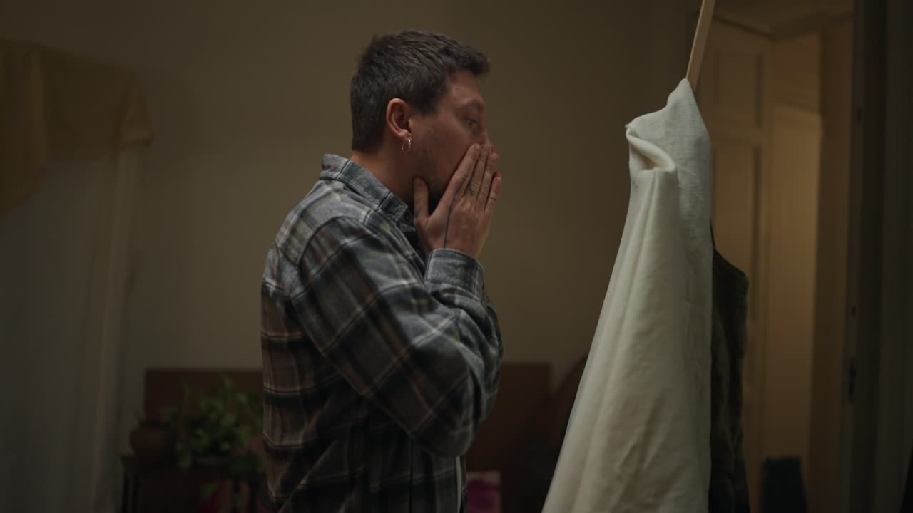 Man Examining Fabric