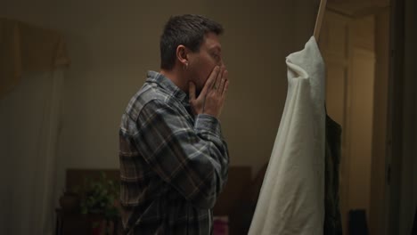 man examining fabric
