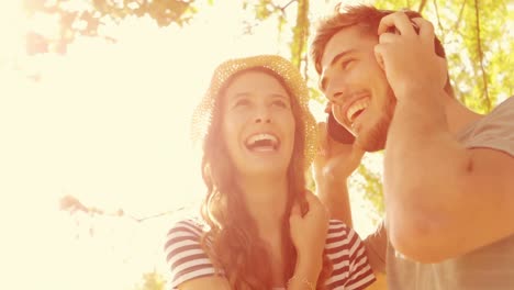 happy couple listening music in the park