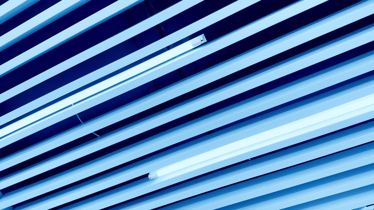 Long lamps of white day light among the decorative planks on the ceiling. Circle movement from low angle perspective.