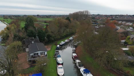 aerial view of canal with boats and autumnal colors