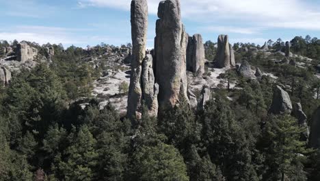 aerial drone fly above creek monk stone valley mexican ancient landscape, rocks archaeological statues around pale green trees desert vegetation, mexico latin american