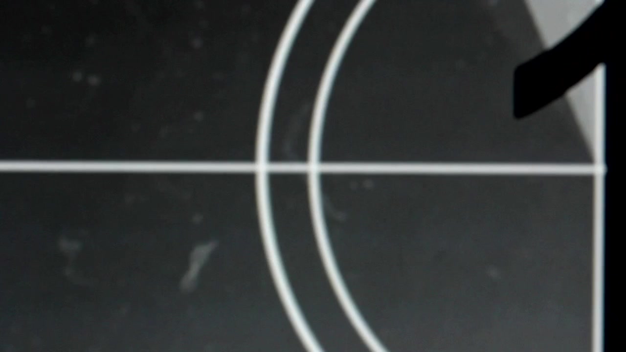 Retro Film Leader Countdown with Flashing Number 7 and Grain