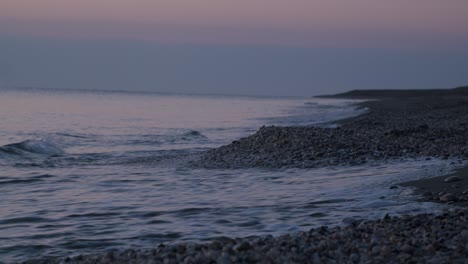 focused shoreline waves crashing rocky beach, sunrise, mojacar, almeria, spain