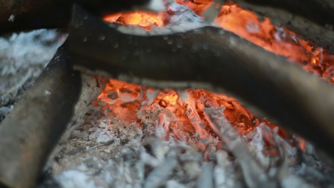 Close Up Of Wood Burning In The Bonfire. Close up of a bonfire with orange flames and firewood