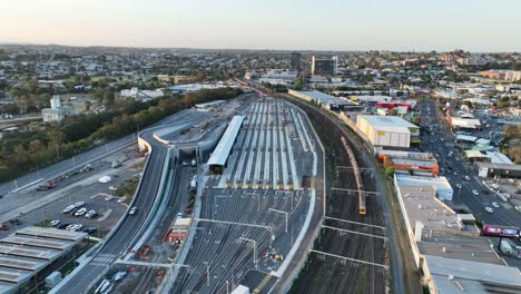 drone shot tracking train crossing brisbane city mayne railway yard