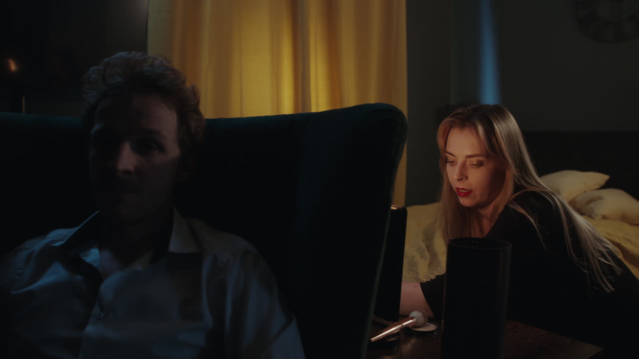 Couple Relaxing in Bedroom at Night