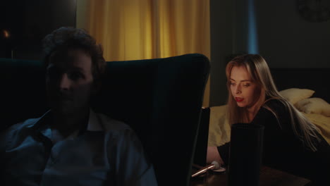 couple relaxing in bedroom at night