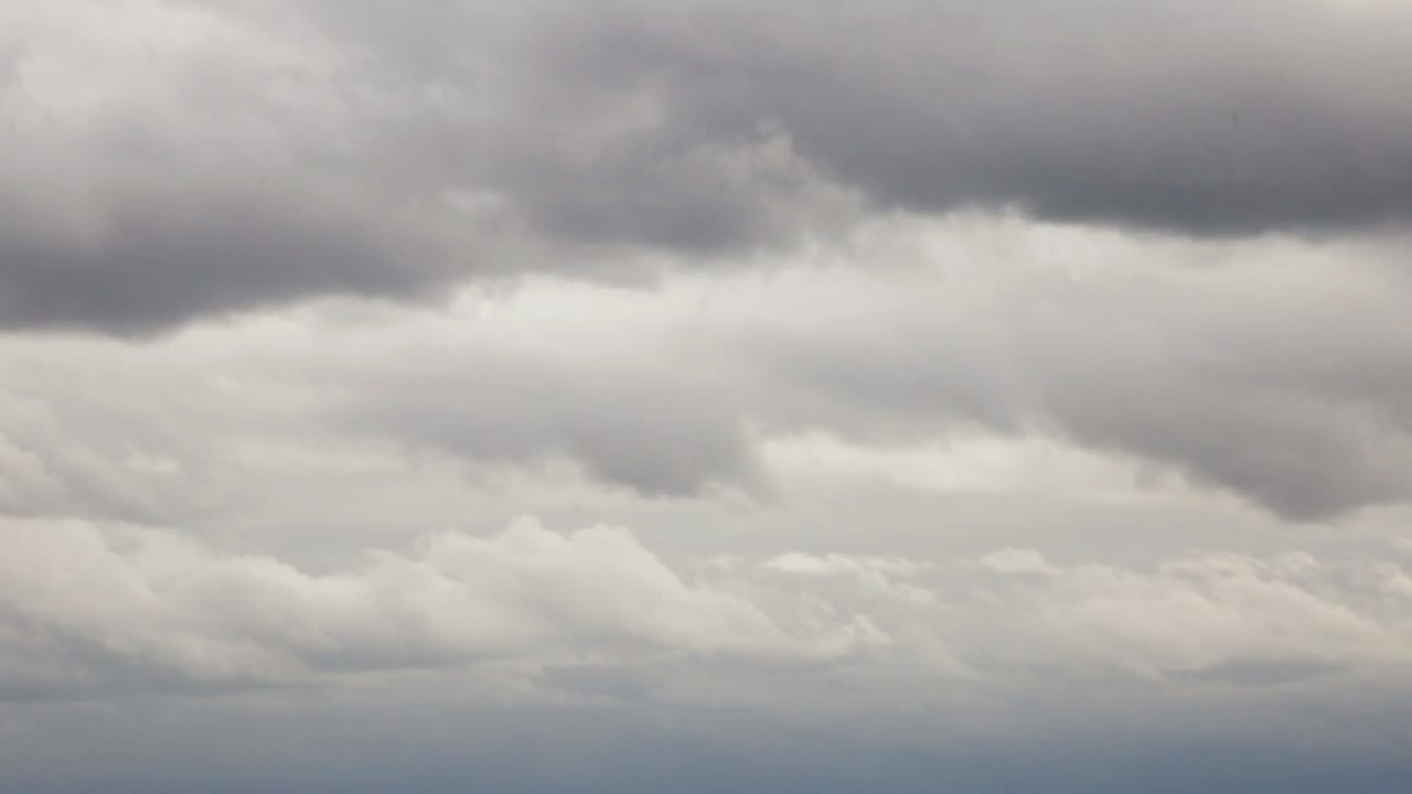 Looking at the fluffy dark rain clouds - Tilt up pan