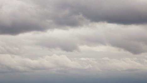 looking at the fluffy dark rain clouds - tilt up pan