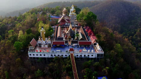 buddhist wat phra that doi temple in mountains at dusk, thailand