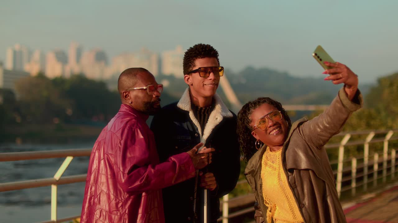 Diverse group of friends taking a selfie outdoors with a city skyline in the background