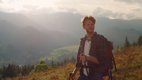 Serious-man-travel-mountains-landscape.-Closeup-tourist-using-trekking-poles.