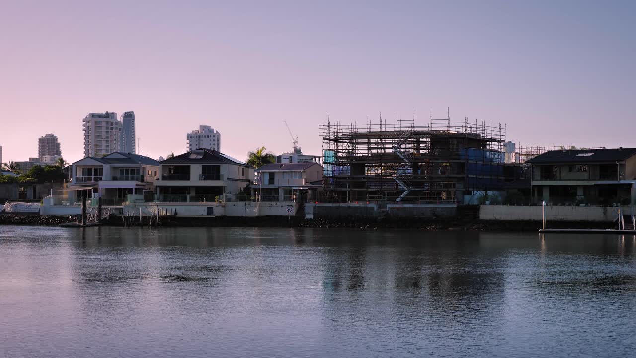 House build along the Nerang River at sunrise on a sunny day, Surfers Paradise, Gold Coast, Queensland, Australia