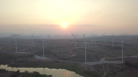 view of wind turbines with sunset