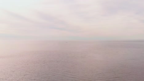 low shot over foggy scene of beautiful baltic blue seascape, eastern europe