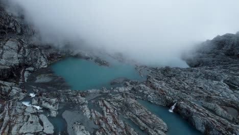 Clouds-rolling-in-to-glacier-lakes-near-Brewster-Glacier-at-Brewster-Track-in-Mount-Aspiring-National-Park,-New-Zealand