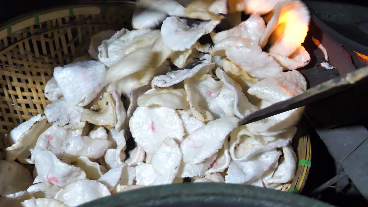 Slow motion shot of Krupuk finished being fried to be sold at market, Indonesia
