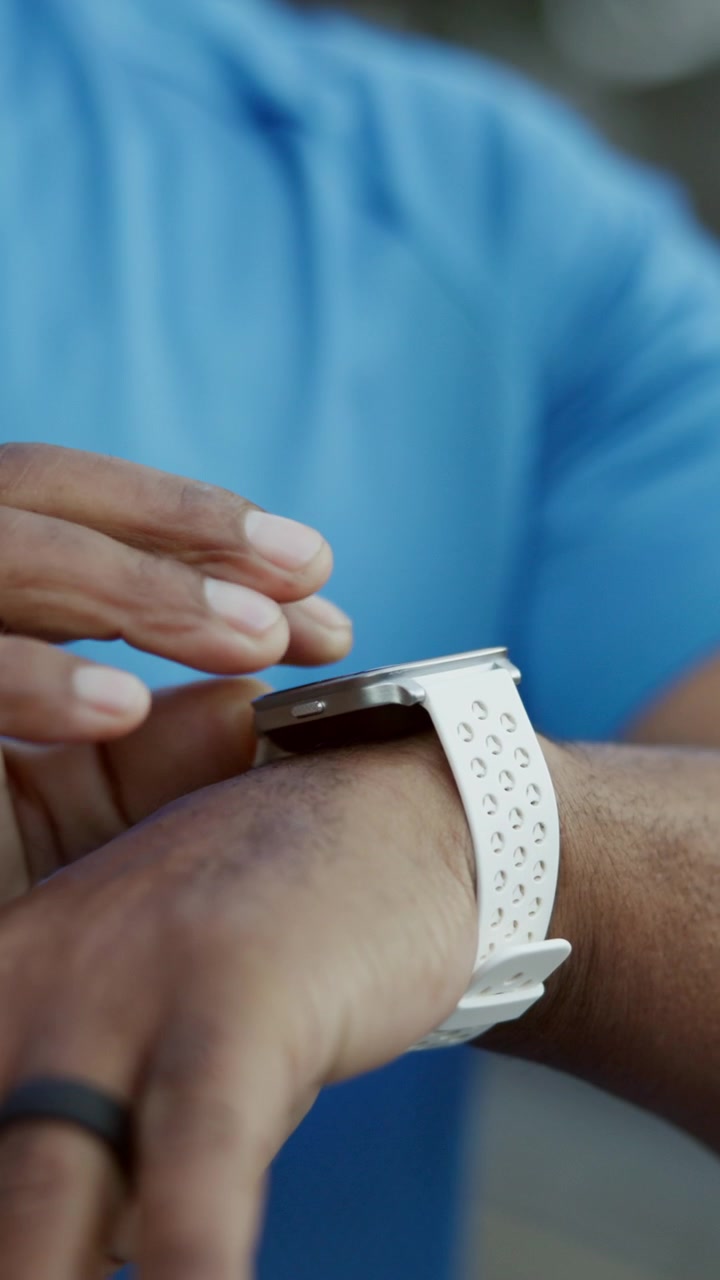 Person Using Smartwatch to Check Fitness Data