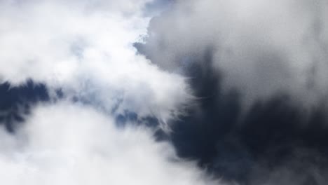 a thunderstorm with lightning striking against a foreground of white clouds