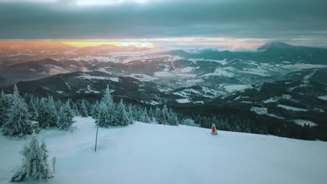 aerial shot of the sun rising in mala fatra mountains covered in snow on a cloudy day, in slovakia