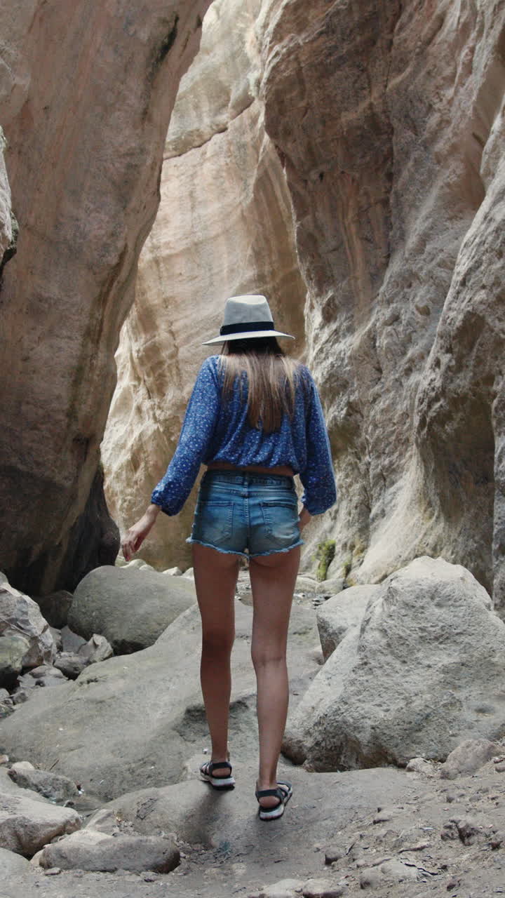 Woman photographing canyon