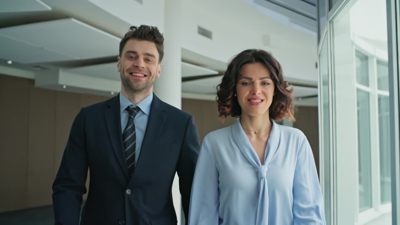 Businesswoman businessman walking corridor office building closeup. Two people