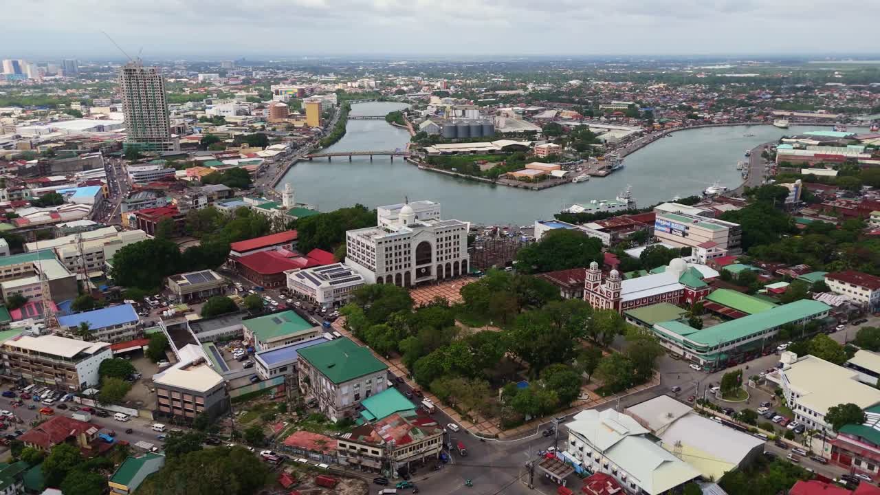 Wide aerial view of the Iloilo River Esplanade and urban landscape in Iloilo City, Philippines. A modern development highlighting the city's growth and natural beauty on Panay Island