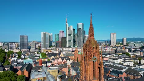 4k aerial drone video of the historic kaiserdom st. bartholomäus church on the banks of the main river in downtown frankfurt, germany